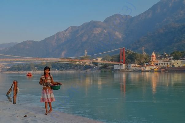 This is a photo I captured of Ram Jhula, Ma Ganga, and flower girl