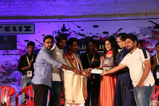 A picture with dignitaries, donating a cheque to littlthought