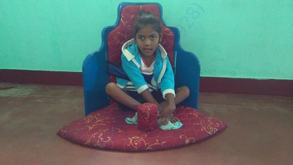 Cerebralpalsy child getting trained for her hip balance in corner seat