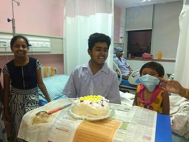 Dhruv cutting his birthday cake while in hospital