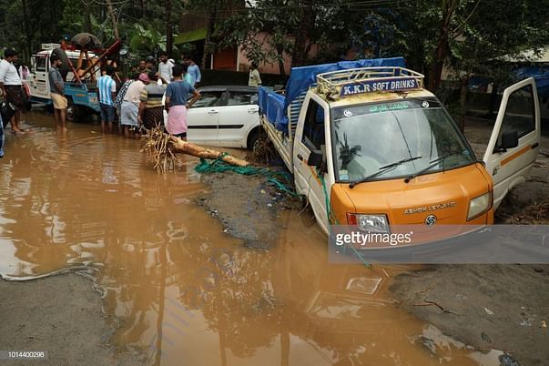 Vehicles stranded or submerged. Roads fully blocked