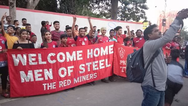 Red Miners welcoming the team back to their home