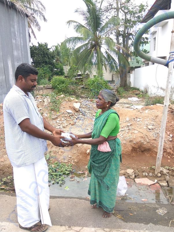 Sukumar distributing food packet
