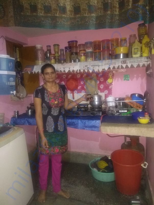 Rekha Devi in her house, working and rearing her three children