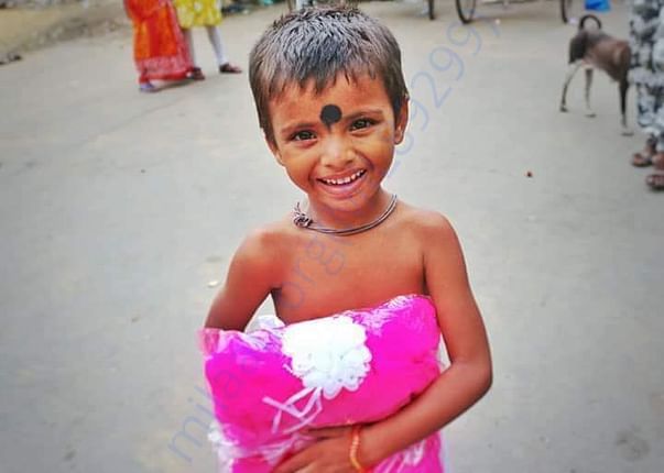 Kids smile after getting clothes