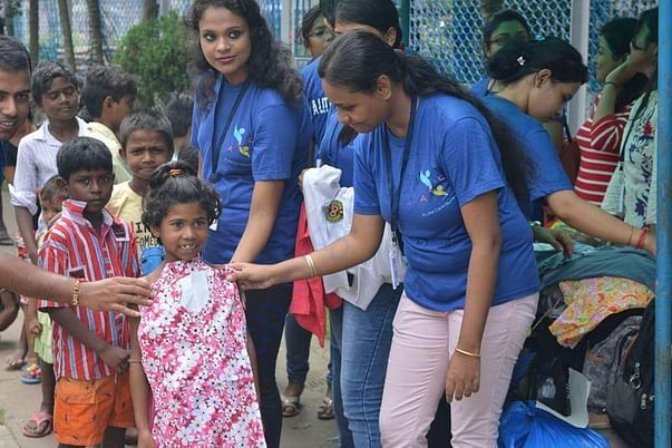 Our Team Member gifting new cloth to a girl