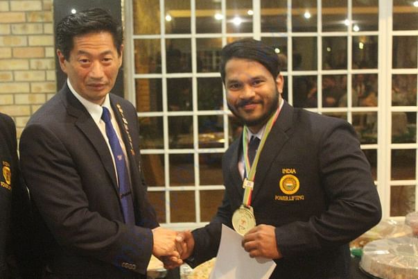 Receiving Best Lifter Award from International Officials at SA