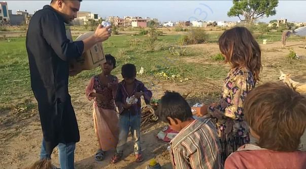 Distributing food among slum children