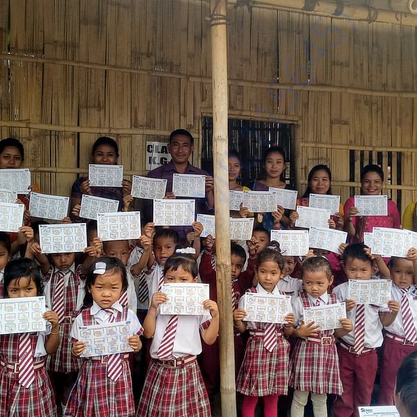 School children and Teachers outside the bamboo wall classroom