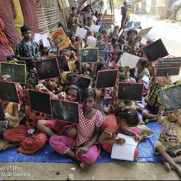Childrens are happy after getting stationary in slum area