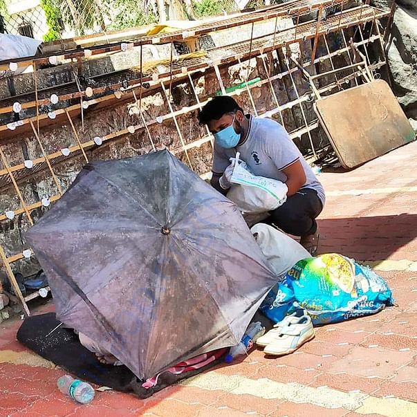 Our Aurangabad Team volunteer helping a homeless person on street .
