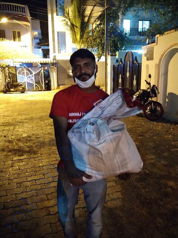 Brother Tahir distributing the food packets to needy families