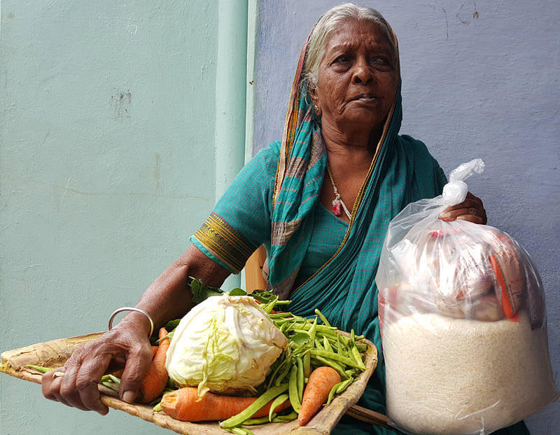 Donating monthly groceries to poor oldagewoman in india helpage person