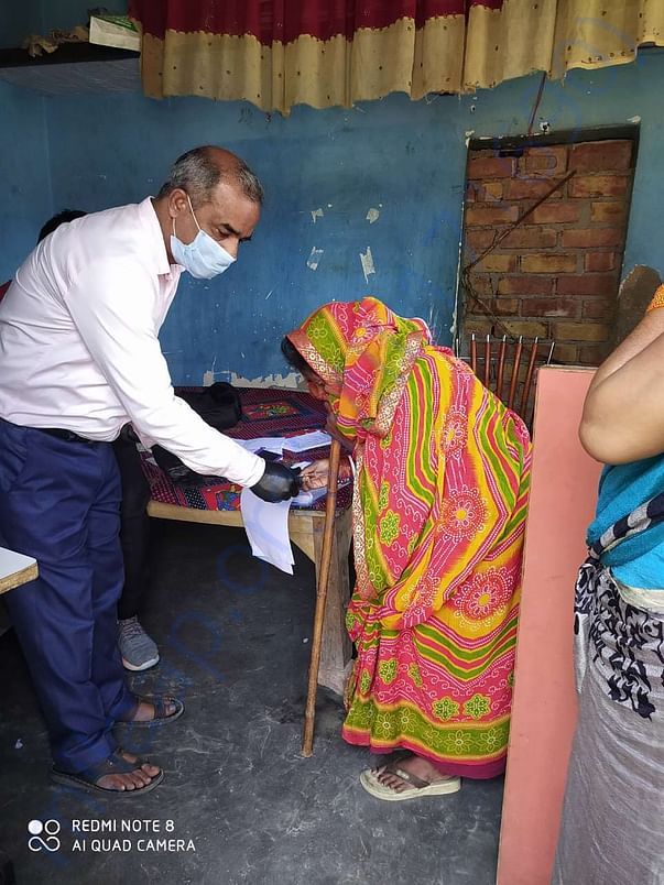 Handing over the cash support to an elderly women