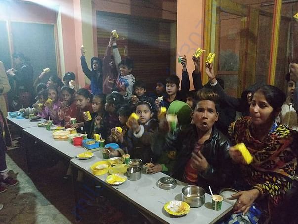 The children enjoying drinks given to them by kind hearted volunteers