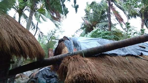 Large scale damage to property with several thatched houses uprooted