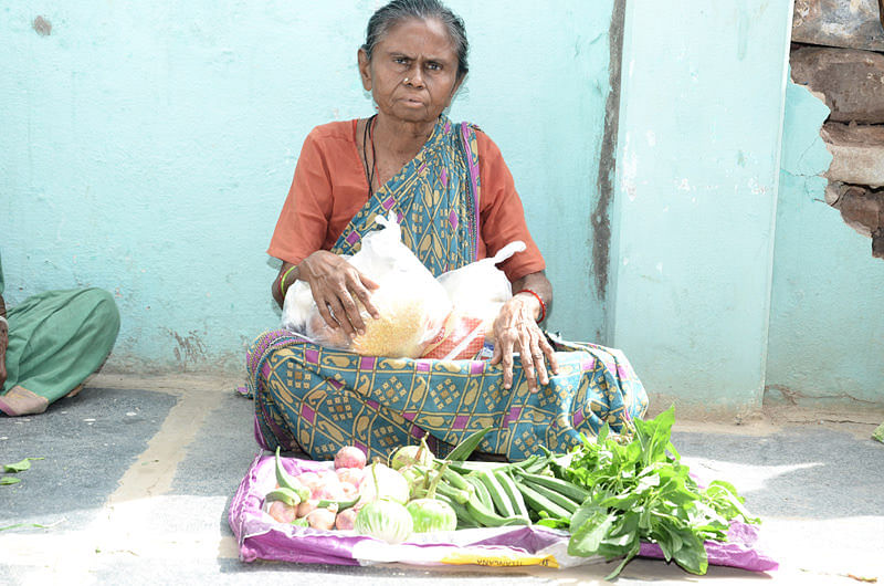 Poor senior citizen getting food provisions in india
